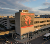 An Alewife Arsonists banner hanging on the side of the Alewife Station parking garage